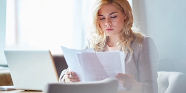 Frau schaut auf Dokumente